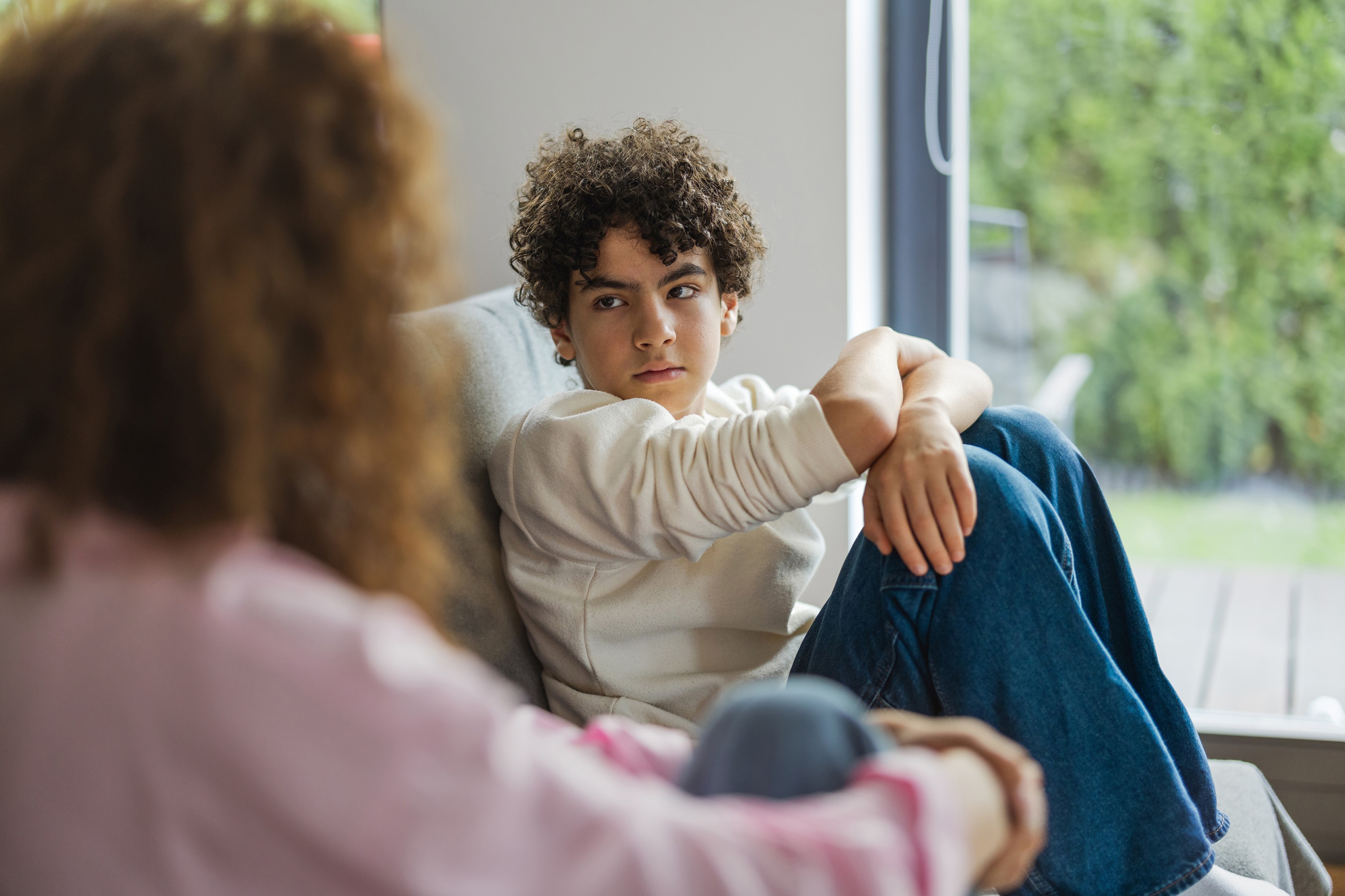 An adult talking with a young person