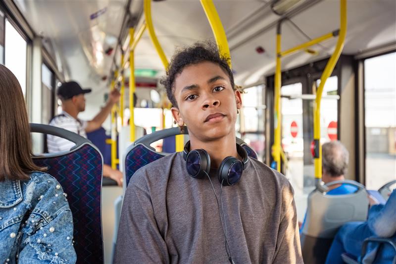 A young person on a bus