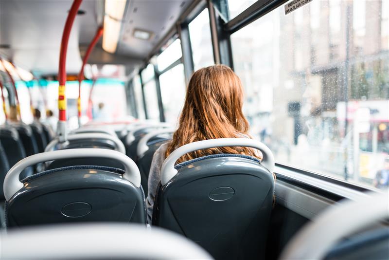 A young person on a bus