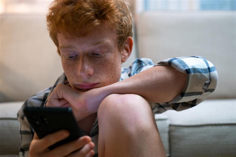 A young person looking at a smartphone